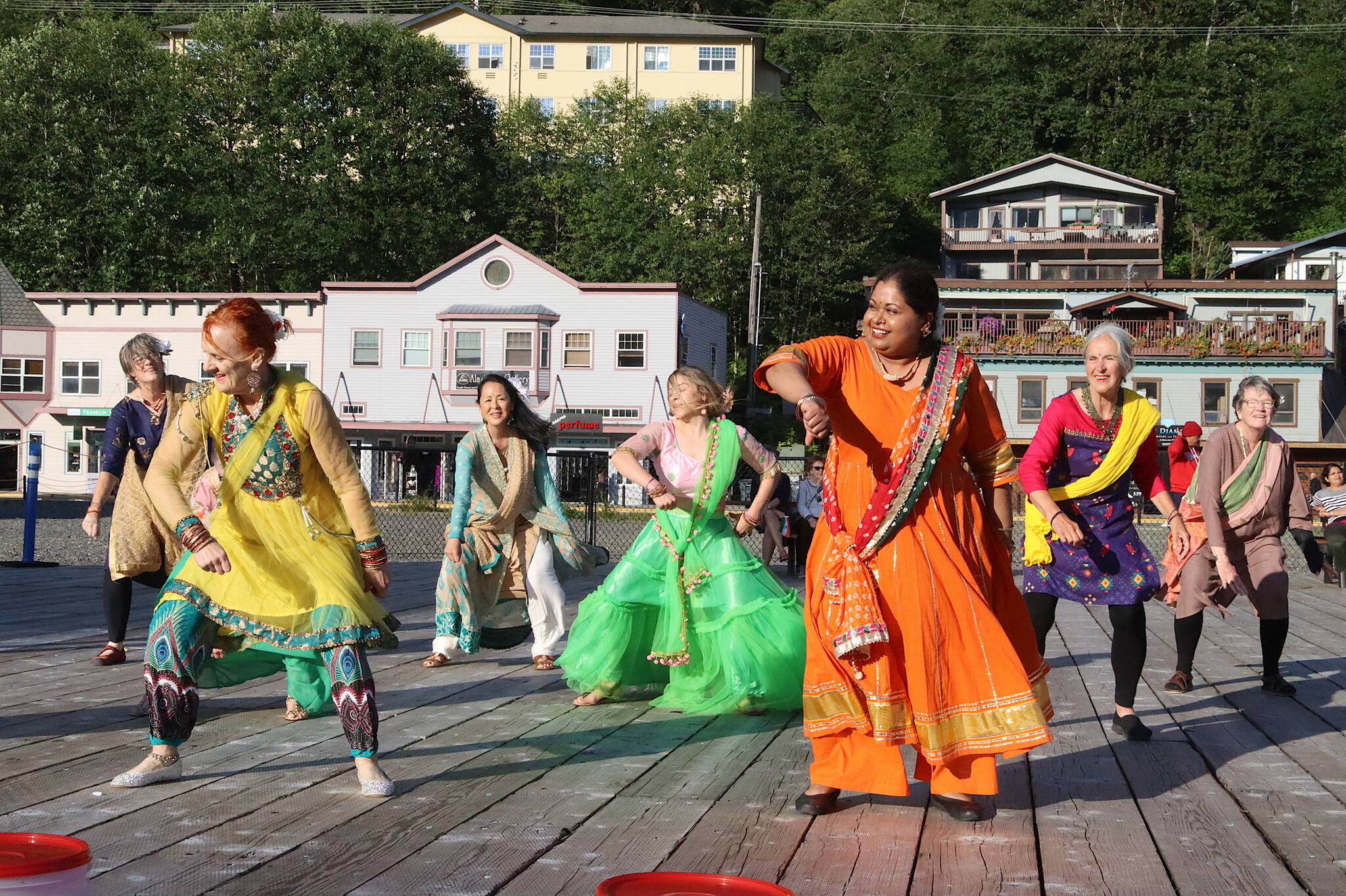 Nimmy Philips (wearing orange) leads a Bollywood flash mob during a celebration of Indias Independence Day on Friday at Elizabeth Peratrovich Plaza. The event was hosted by downtown businesses who presented a $10,000 donation to the Juneau Community Foundation to aid people affected by record flooding of the Mendenhall River earlier this month. (Mark Sabbatini / Juneau Empire)