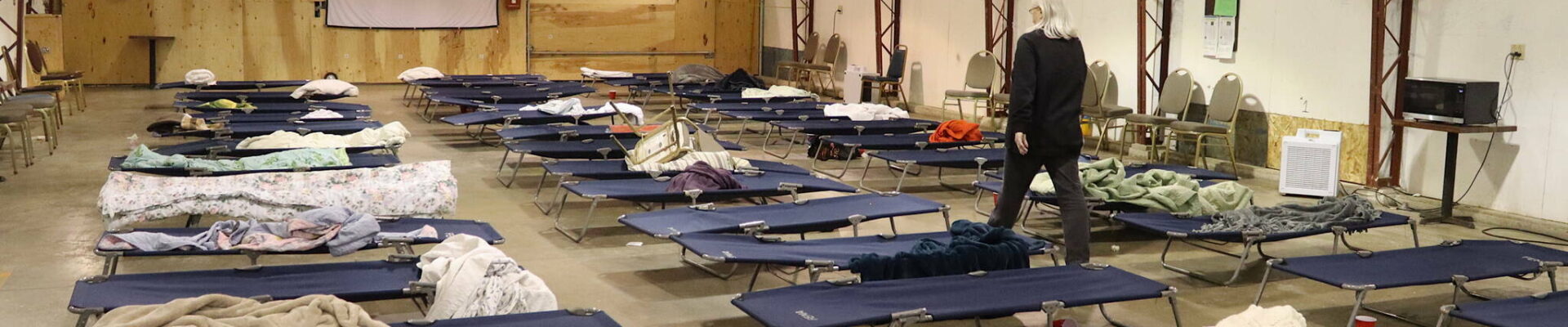Jackie Bryant, director of the citys cold-weather emergency shelter during its first season, inspects cots after people staying there depart on Wednesday, March 27, 2024. (Mark Sabbatini / Juneau Empire file photo)