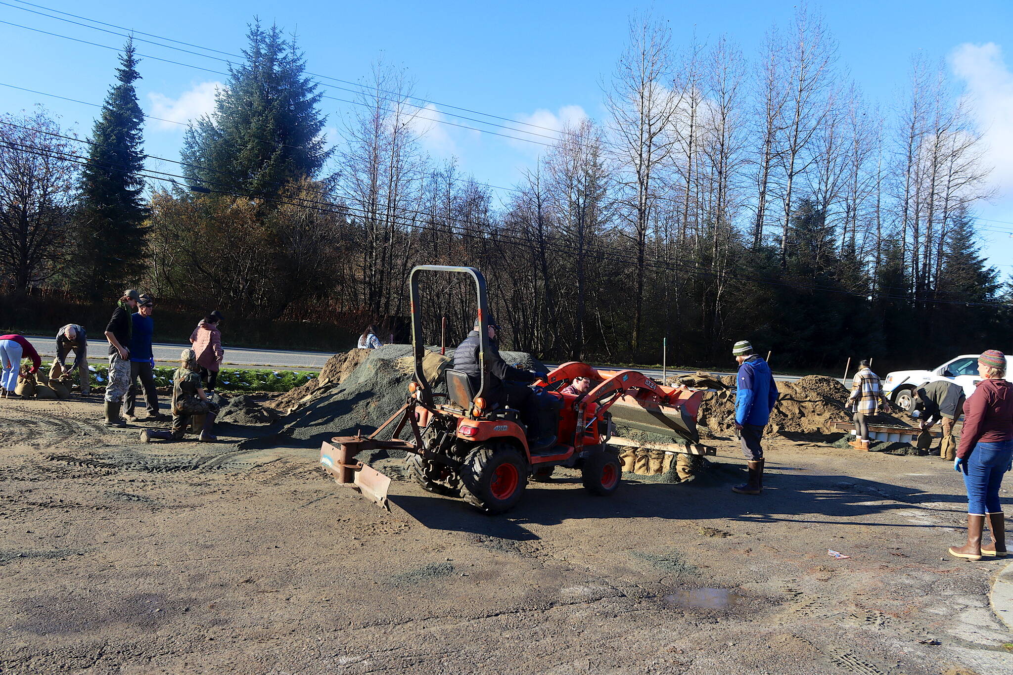 Tom Mattice, Juneaus emergency programs manager, uses a loader to help residents fill sandbags at Melvin Park on Sunday afternoon. The city is distributing 75,000 sandbags for free, with sand available at the park and the Thunder Mountain Middle School parking lot. (Mark Sabbatini / Juneau Empire)