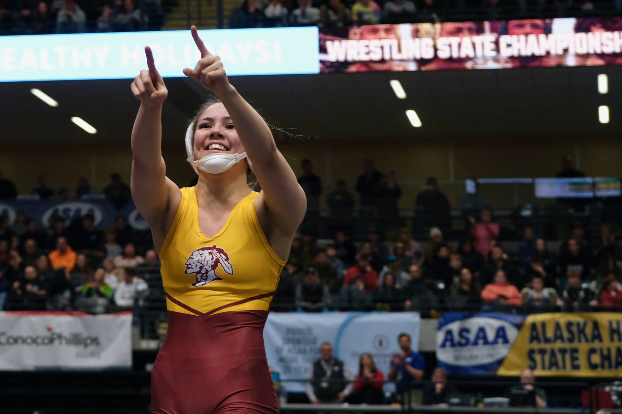 Hoonah senior Krista Howland points to the crowd after pinning Soldotnas Rowan Peck in the girls 126-pound title match during the 2024 ASAA/First National Bank Alaska Wrestling State Championships on Saturday at Anchorages Alaska Airlines Center. (Klas Stolpe / Juneau Empire)