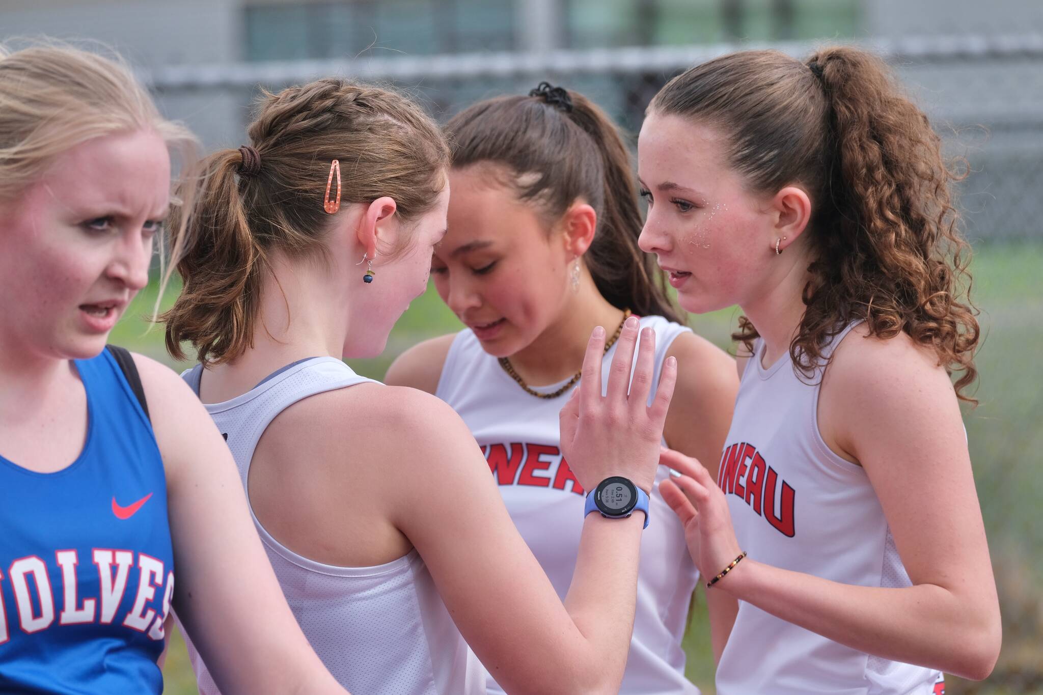 Juneau-Douglas High School: Yadaa.at Kalé junior distance runners Della Mearig and Lua Mangaccat and freshman Sunna Schane congratulate each other during an event at the Capital City Classic this year. The Region V Track & Field championships are Friday and Saturday at Thunder Mountain Middle School. (Klas Stolpe / Juneau Empire)