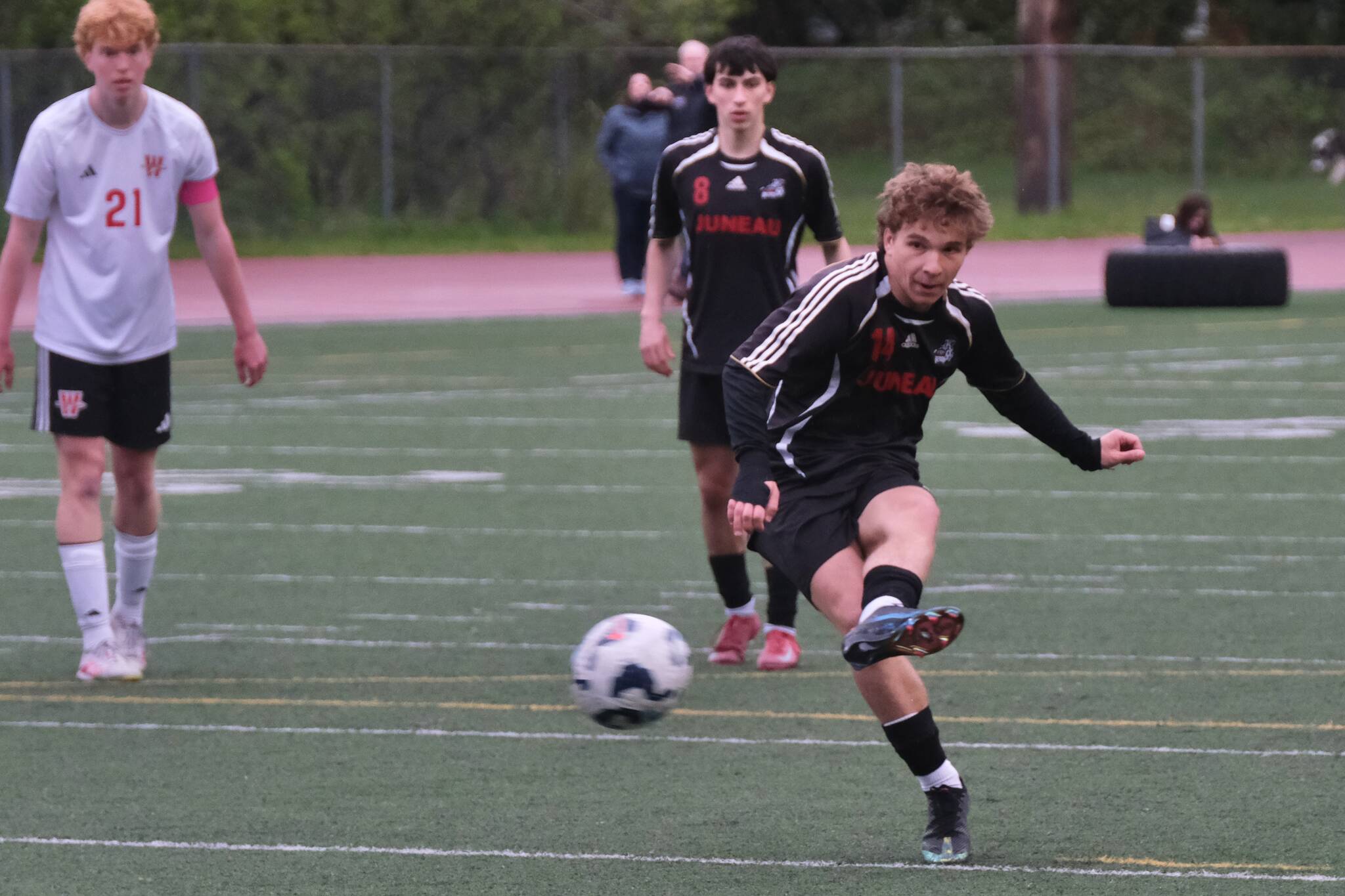 Juneau-Douglas High School: Yadaa.at Kalé senior Kai Ciambor hits a penalty kick to break the Crimson Bears’ career scoring record during Saturday’s Crimson Bears senior appreciation game at Adair-Kennedy Memorial Park. (Klas Stolpe / Juneau Empire)