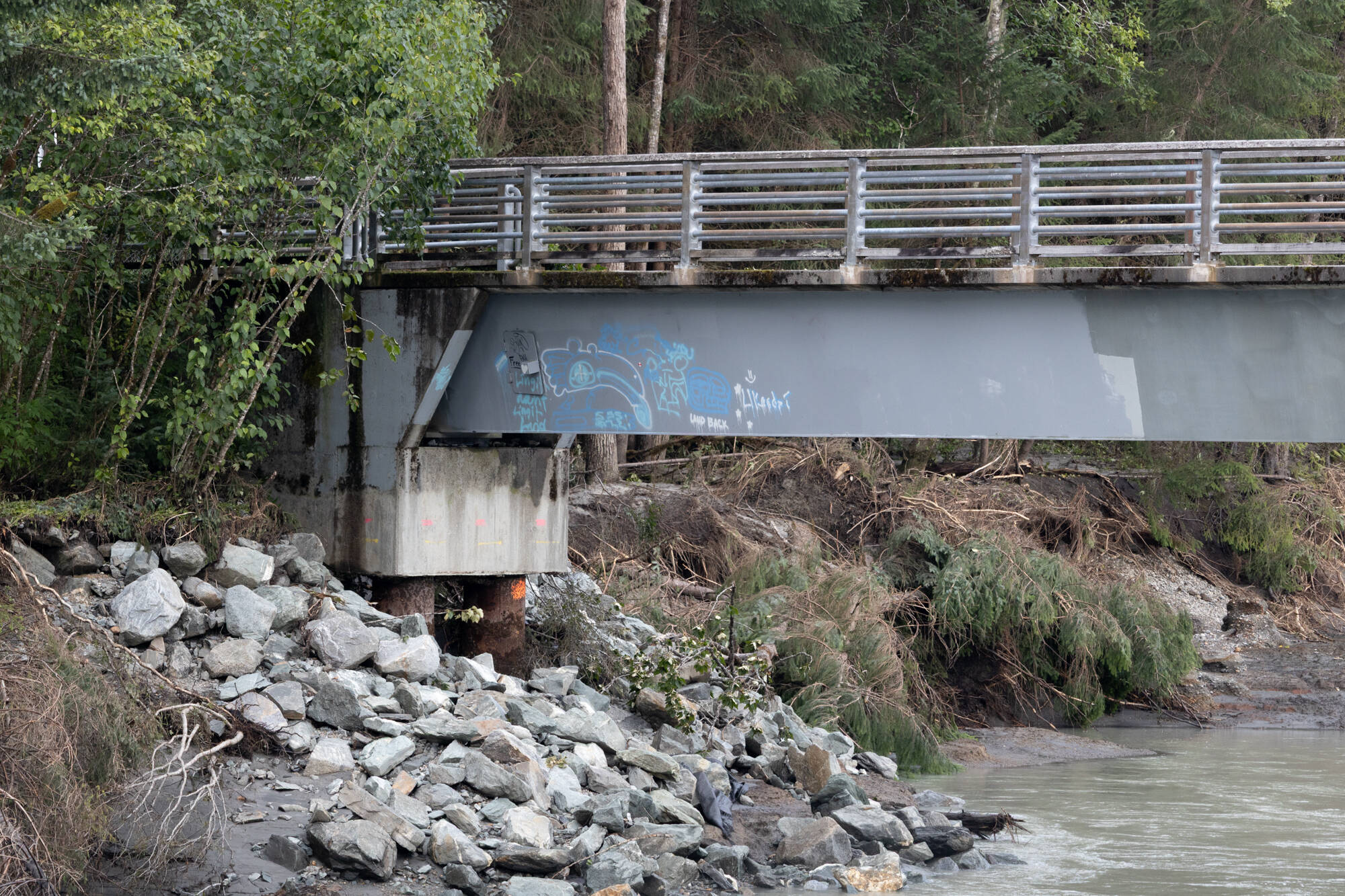Damage to the Mendenhall foot bridge caused by a record-breaking glacial outburst flood on Aug. 13 is pictured on Aug. 15, 2025, in Juneau, Alaska. (Chloe Anderson/Juneau Empire)