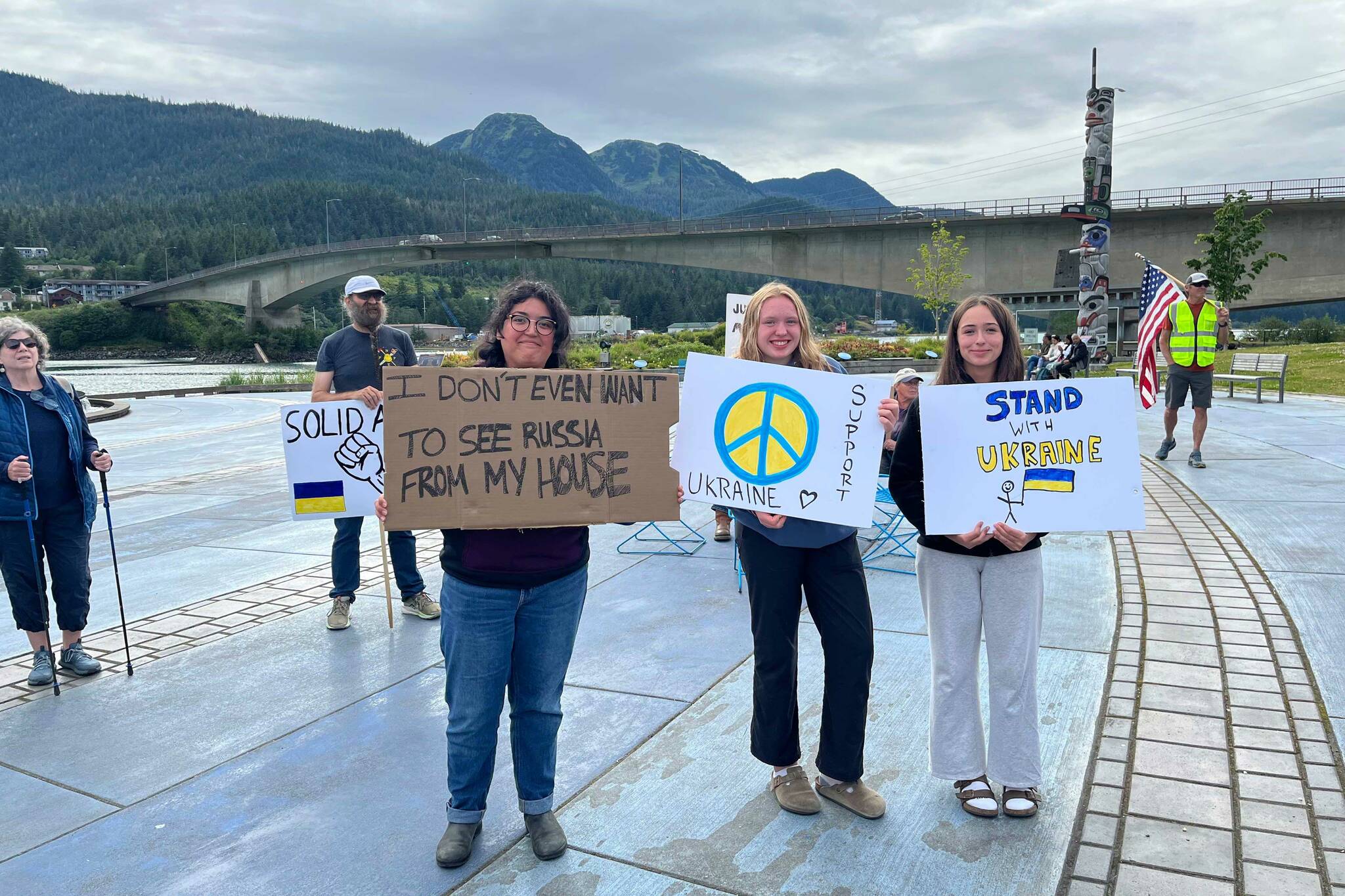 Protesters hold signs at the “No War Criminals” protest at The Whale in Bill Overstreet Park in Juneau, Alaska, on Friday, Aug. 15, 2025. (Photo provided by Juneau For Democracy)