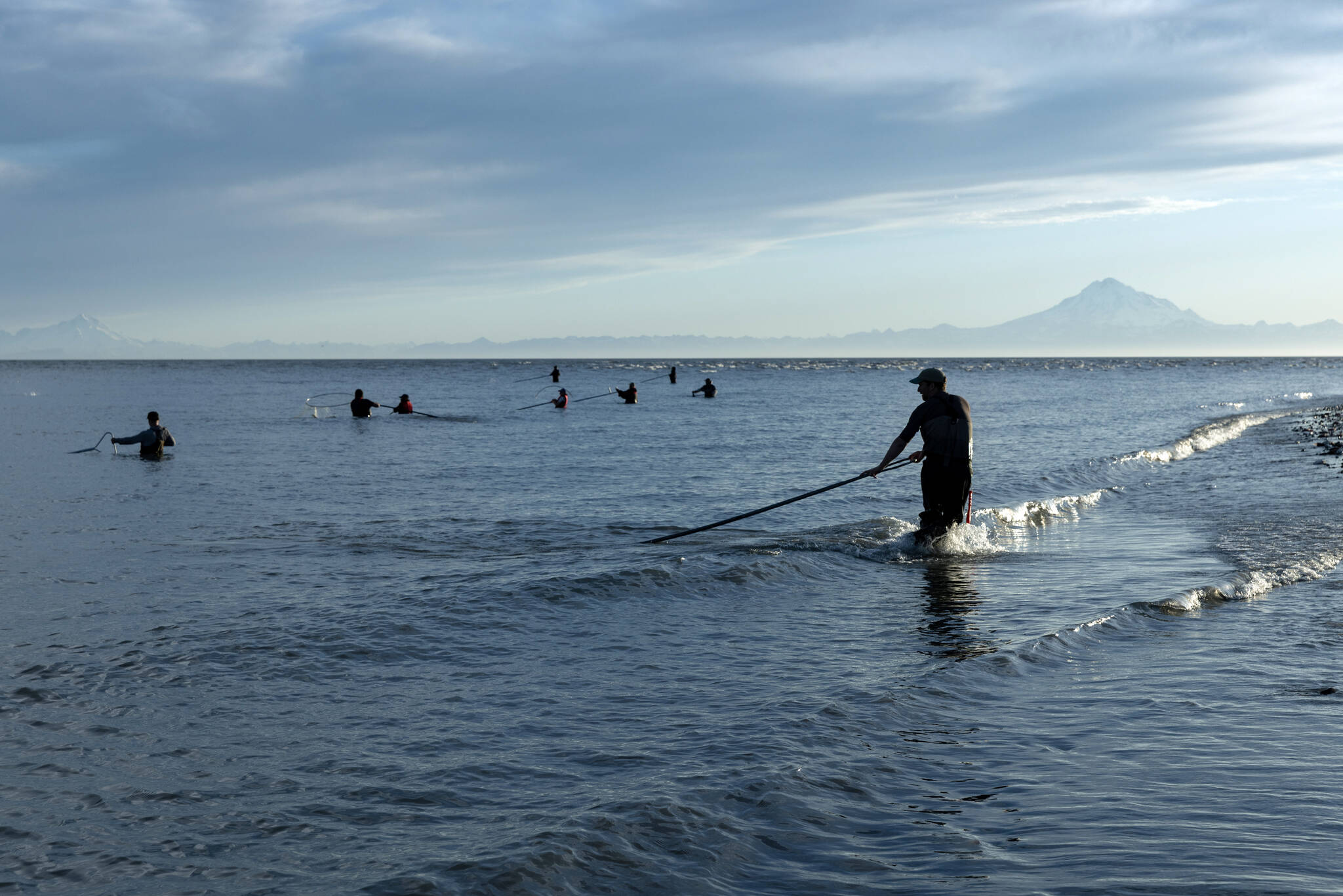 Local fishermen use dipnets to catch salmon at the mouth of Alaska’s Kenai River, where it runs into Cook Inlet, on July 21, 2025. The looming energy crisis in Anchorage offers a lesson in the downsides of relying on fossil fuels. (Nathaniel Wilder/The New York Times)