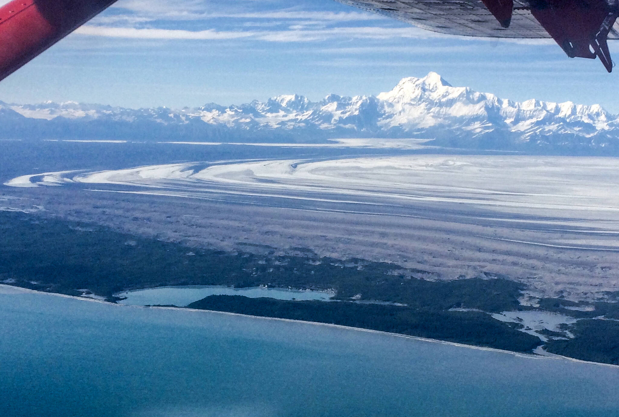 The 18,008-foot Mount St. Elias rises above Malaspina Glacier and Sitkagi Lagoon (water body center left) in 2021. (Photo by Martin Truffer)