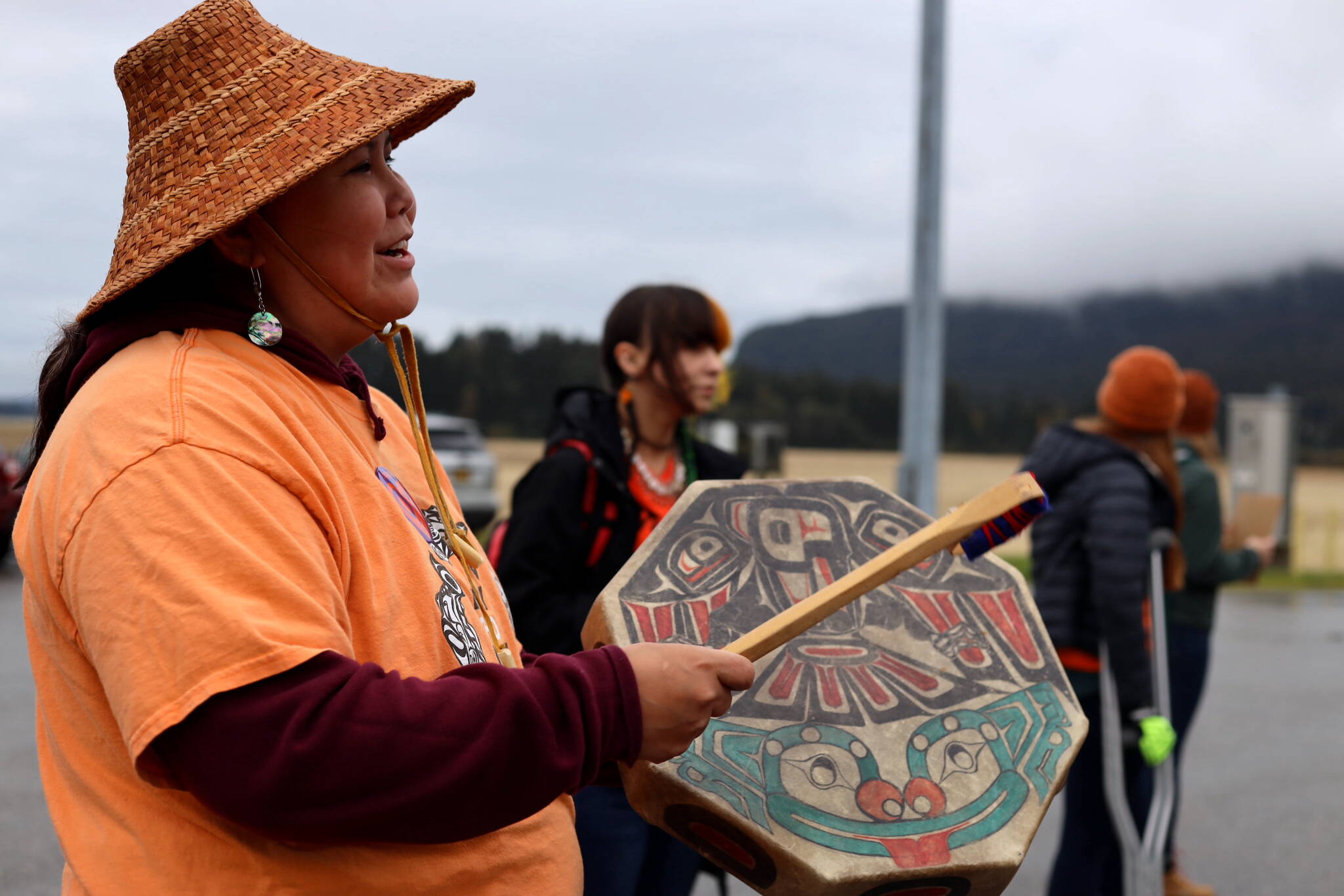 Natalie Brown plays a drum and sings during an Orange Shirt Day event near the Mendenhall Wetlands viewing area in Juneau on Saturday, Sept. 30, 2023. (Clarise Larson / Juneau Empire)