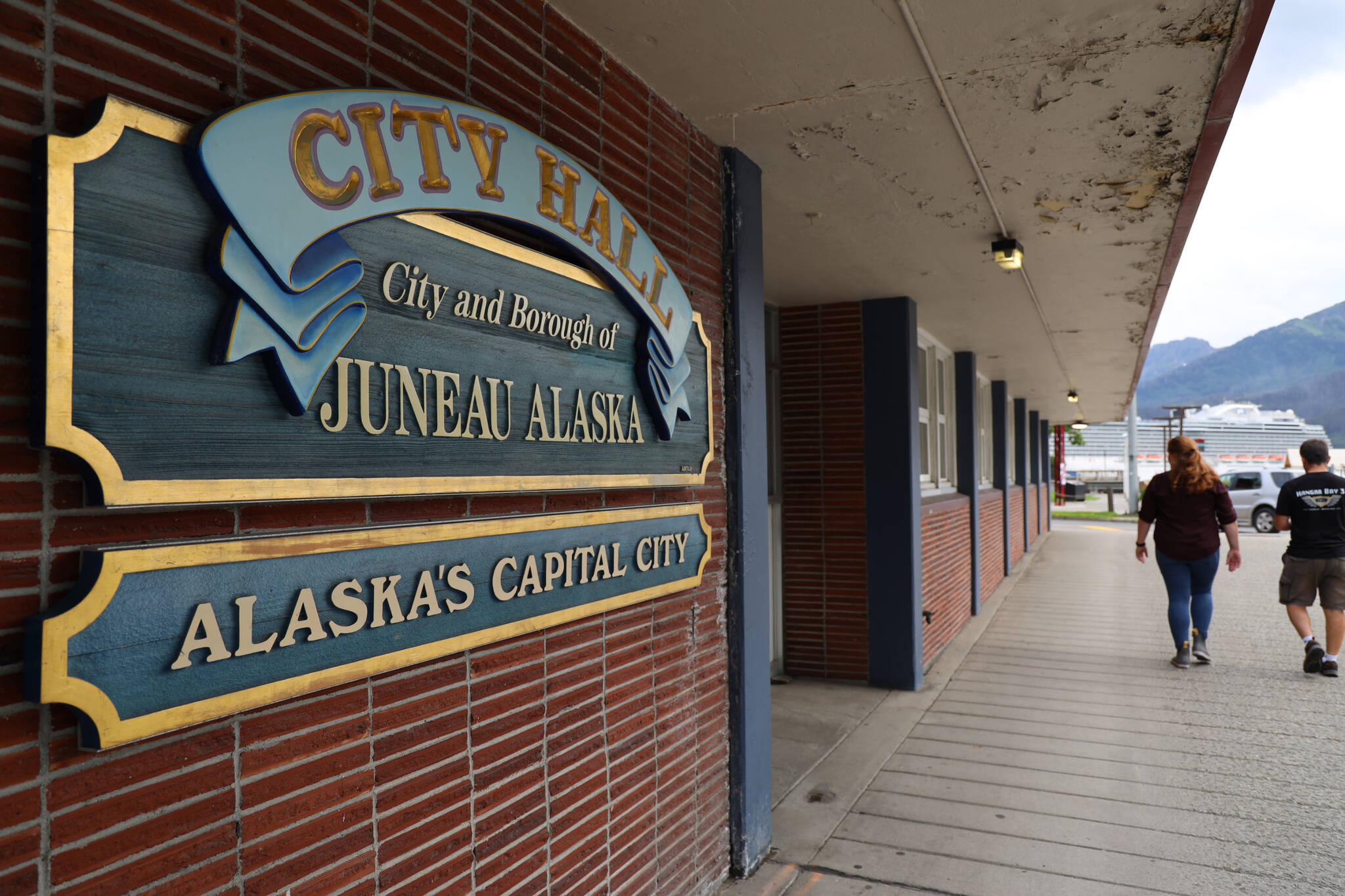 People walk past City Hall in downtown Juneau. (Clarise Larson / Juneau Empire)