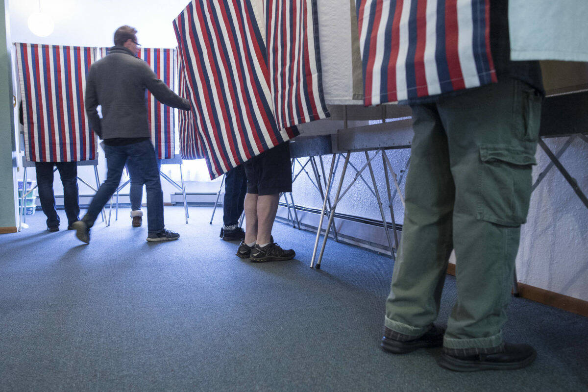 In this Nov. 6, 2018 photo, voters fill the voting booths at Glacier Valley Baptist Church on Election Day. (Michael Penn | Juneau Empire File)