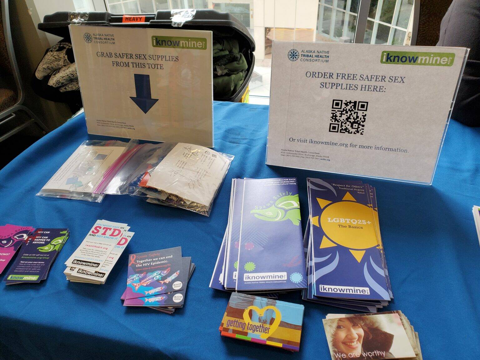 Brochures available on Oct. 17, 2023, at the Youth and Elders Conference in Anchorage give information on safer sex and avoidance of sexually transmitted infections. Alaska has long had among the nation’s highest rates for some sexually transmitted infections, but case numbers declined in 2024. (Photo by Yereth Rosen/Alaska Beacon)