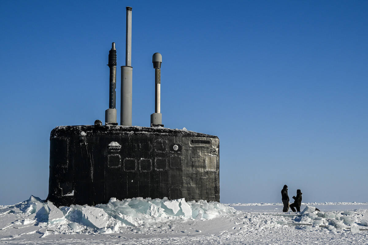 FILE — Cew of the USS Hampton, a Los Angeles class submarine, out on the ice after surfacing in the Beaufort Sea during Operation Ice Camp, March 16, 2024. The Trump administration is emphasizing defense concerns instead of climate research in the rapidly warming Arctic region. (Kenny Holston/The New York Times)
