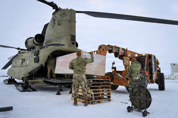 Members of the Alaska Air and Army National Guard, Alaska Naval Militia, and Alaska State Defense Force work together to load plywood onto a CH-47 Chinook helicopter, in Bethel, Alaska, Nov. 2, 2025, bound for the villages of Napaskiak, Tuntutuliak, and Napakiak. The materials will help residents rebuild homes and restore community spaces damaged by past storms. (U.S. Army National Guard photo by Spc. Ericka Gillespie)