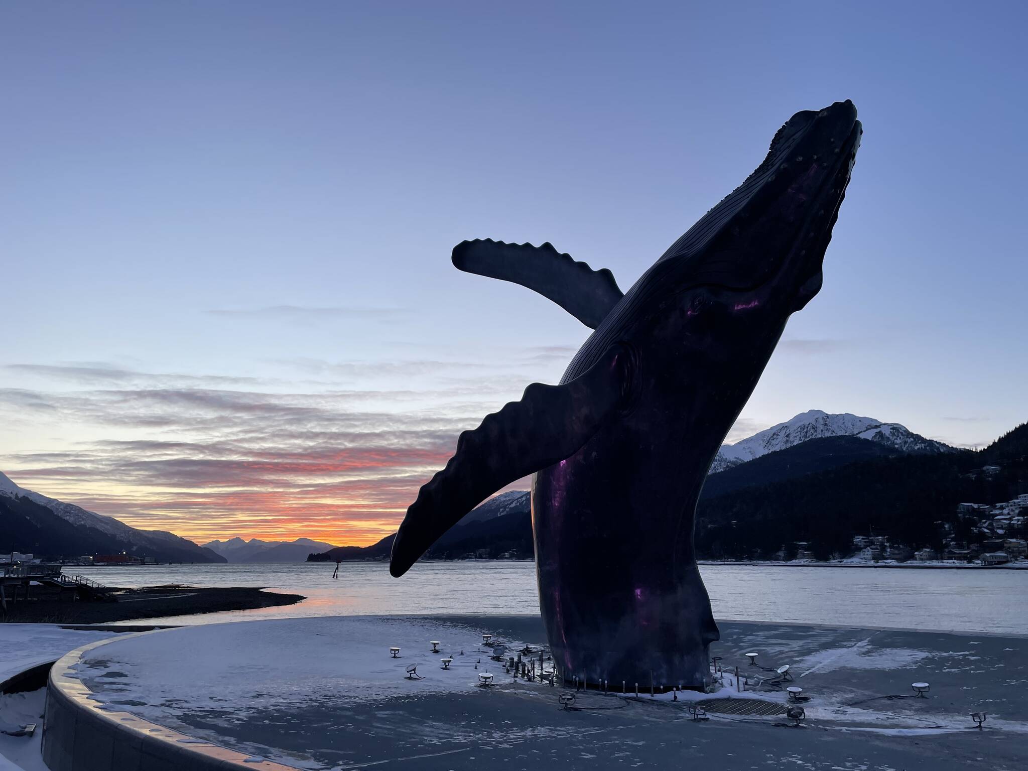 The whale sculpture at Overstreet park breaches at sunrise on Friday, Dec. 19, 2025. (Mari Kanagy/Juneau Empire)