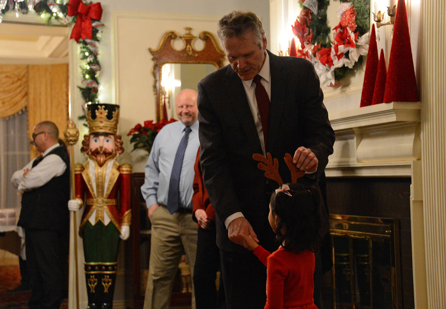 Photo by James Brooks / Alaska Beacon
Alaska Gov. Mike Dunleavy greets a child during the governors annual holiday open house on Tuesday, Dec. 12, 2022 at the Governors Mansion in Juneau.