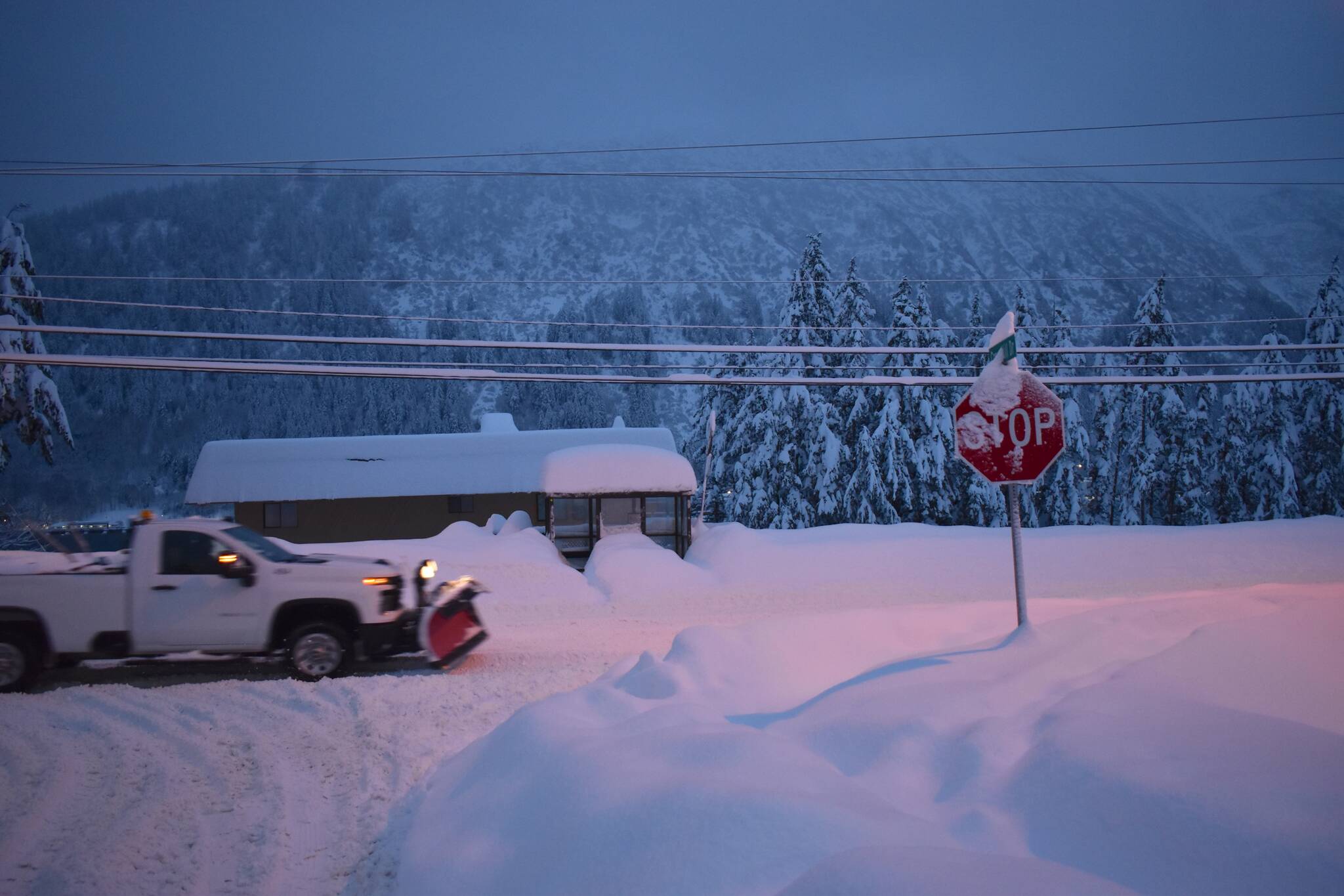 A truck with a snowplow drives along Douglas Highway on Dec. 31, 2025. (Mari Kanagy / Juneau Empire)