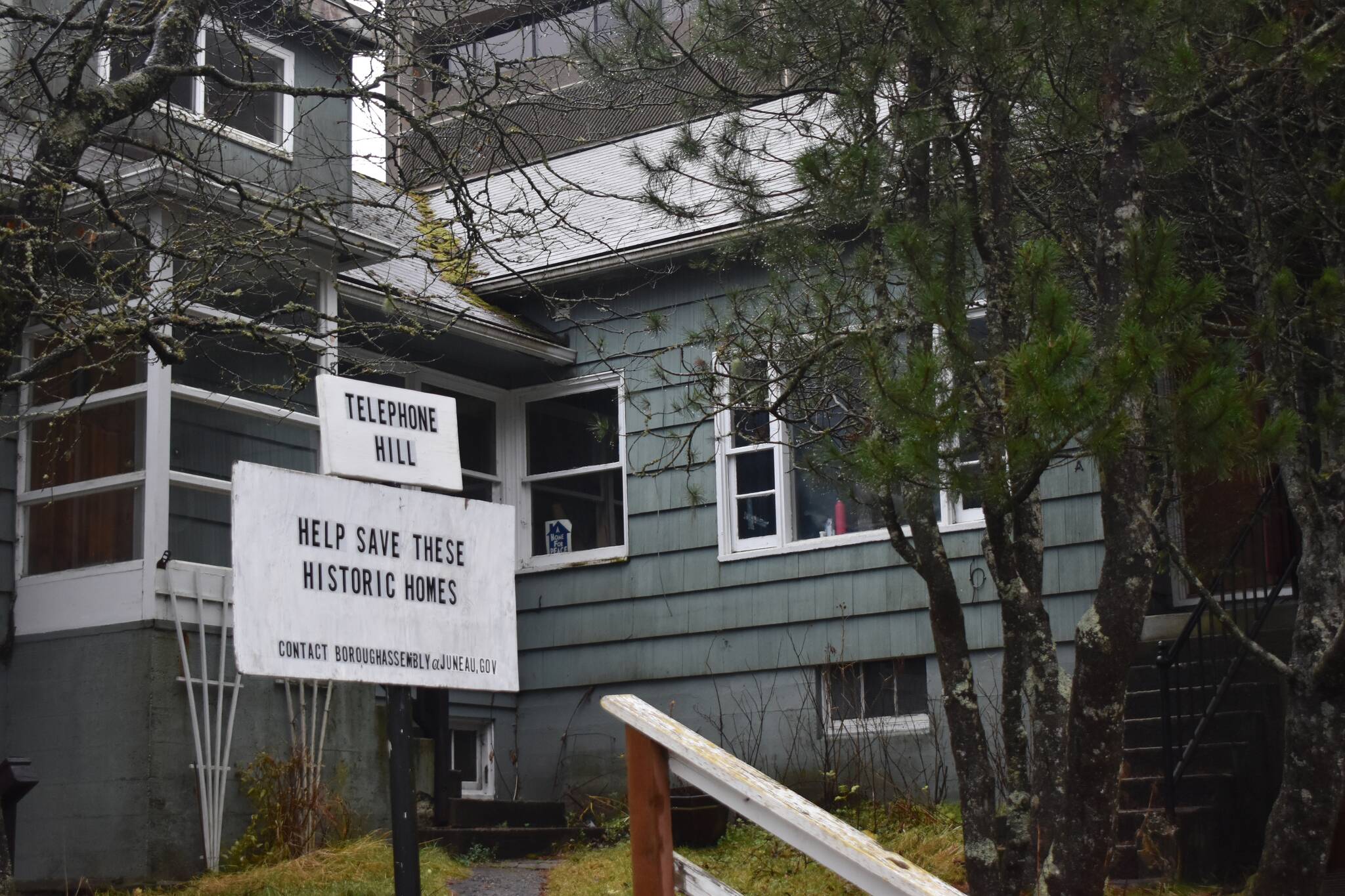 A sign reading, "Help Save These Historic Homes" is posted in front of a residence on Telephone Hill on Friday Nov. 21, 2025. (Mari Kanagy / Juneau Empire)