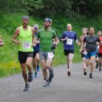 Seth Rutt (yellow singlet) leads a pack of runners on Basin Road during the start of the Perseverance Trail Run/Ben Blackgoat Memorial on Saturday. Rutt finished the 7-mile course in second place behind Allan Spangler (not pictured). (Nolin Ainsworth | Juneau Empire)