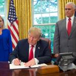 President Donald Trump signs an executive order to keep families together at the border, but says that the zero-tolerance prosecution policy will continue, during an event in the Oval Office of the White House in Washington, Wednesday, June 20, 2018. Standing behind Trump are Homeland Security Secretary Kirstjen Nielsen, left, and Vice President Mike Pence. (Martinez Monsivais | The Associated Press)