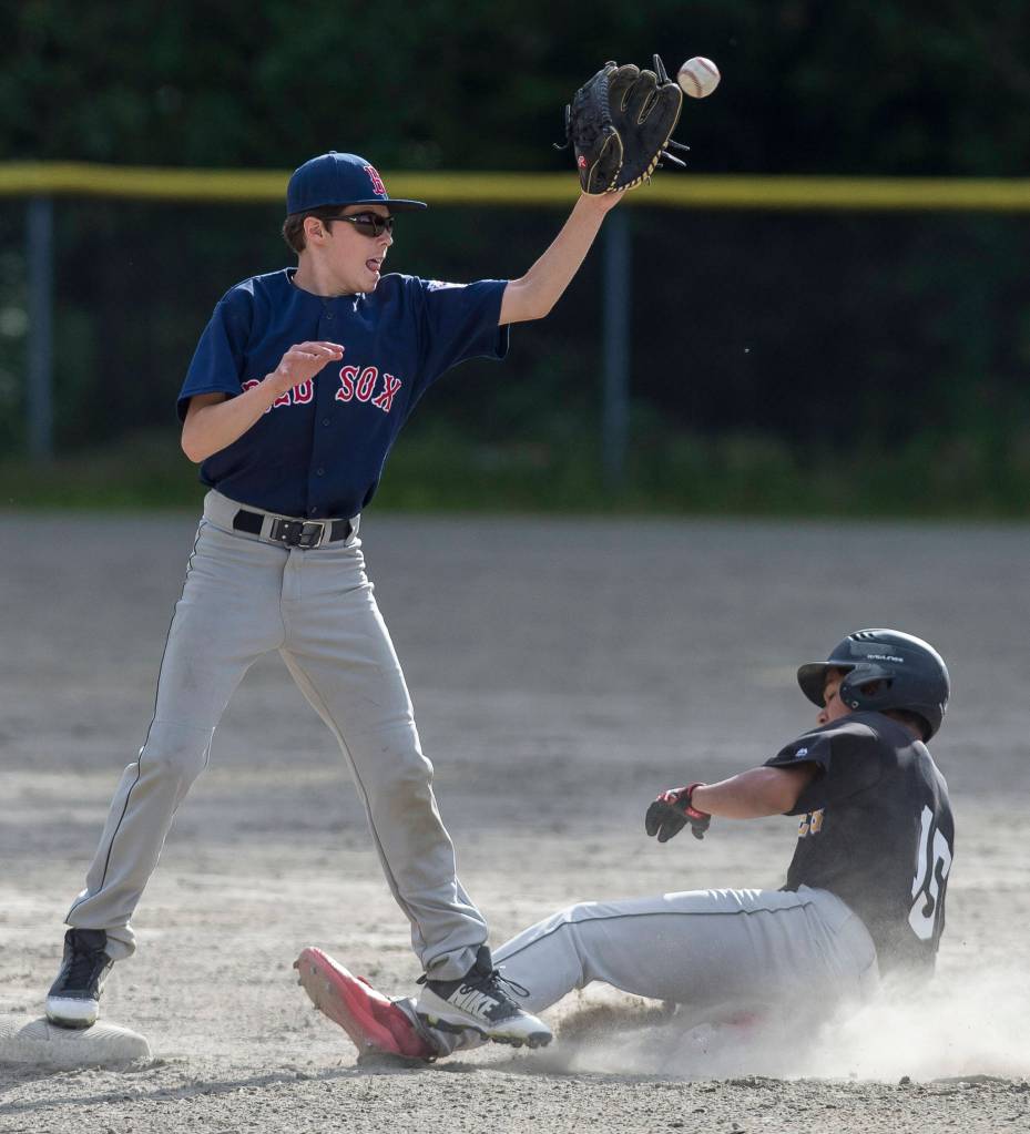 Pirates Rae Razor steals second base under the tag by Red Soxs Caden Mesdag in the first inning at the Gastineau Channel Little League Junior Division Championship game at Adair-Kennedy Memorial Park on Friday. (Michael Penn | Juneau Empire)