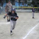 Marlins player Nilsen Nelson watches the ball as he comes home to score in the Gastineau Channel Little League Minor Division Championship game on Saturday at Miller Field. (Nolin Ainsworth | Juneau Empire)