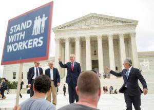 Illinois Gov. Bruce Rauner gives a thumbs up outside the Supreme Court, Wednesday, June 27, 2018 in Washington. From left are, Liberty Justice Centers Director of Litigation Jacob Huebert, plaintiff Mark Janus, Rauner, and Liberty Justice Center founder and chairman John Tillman. The Supreme Court ruled Wednesday that government workers cant be forced to contribute to labor unions that represent them in collective bargaining, dealing a serious financial blow to organized labor. (AP Photo | Andrew Harnik)