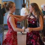 Ellie Knapp and Adelie McMillan dance together at the annual pre-fireworks Barn Dance at St. Anns Parish Hall Tueday, July 3. (Gregory Philson | Juneau Empire)
