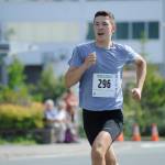 Zach Bursell sprints to the finish line of the Glenn Frick Memorial Mile, which took place just before the start of the Juneau Fourth of July Parade on Wednesday morning. Bursell placed first overall and set a new course record in the mile. (Nolin Ainsworth | Juneau Empire)