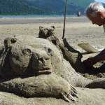 Lee Stoops works on a brown bear and cub sand sculpture Wednesday during a sand sculpting contest at Sandy Beach. (Kevin Gullufsen | Juneau Empire)