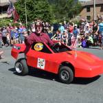 A member of the Juneau-Douglas Shrine Club waves a flag in the Douglas Fourth of July parade on Wednesday. (Kevin Gullufsen | Juneau Empire)