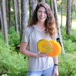 Morgan Johnson, 21, stands in the woods behind John Pugh Hall on the campus of the University of Alaska Southeast, the site of future disc golf course she is building. (Nolin Ainsworth | Juneau Empire)