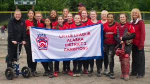 The GCLL Major Softball All-Stars pose with their Alaska District 2 championship banner after defeating Ketchikan Little League, 6-3, in the championship game. (Nolin Ainsworth | Juneau Empire)