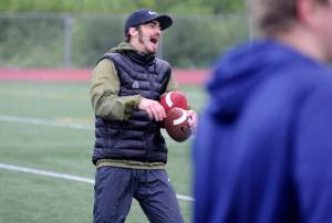 Former Western Oregon University receiver Paul Revis enjoys a lighter moment during the Football Skills, Strength and Speed Camp at Thunder Mountain High School on Wednesday. Revis set over 20 WOU school records, including most receptions, receiving yards, receiving touchdowns and all-purpose yards, in his time at WOU. (Nolin Ainsworth | Juneau Empire)