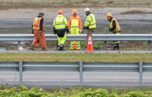 A Department of Transportation and Public Facilities crew finishes the replacement of a section of guard rail on Egan Drive on Monday, July 16, 2018, that was taken out by a drunk driver over the weekend. (Michael Penn | Juneau Empire)