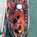 Coast Guard Cutter Douglas Munro crew members assist a survivor off a Coast Guard small boat in Glacier Bay National Park, July 15, 2018. Rough waters overturned four kayaks in Glacier Bay National Park, but the individuals made it to shore and activated their personal locator beacon, which assisted the Coast Guard in locating them. (U.S. Coast Guard | Courtesy Photo)
