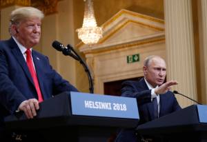 U.S. President Donald Trump, left, listens to Russian President Vladimir Putin during a press conference after their meeting at the Presidential Palace in Helsinki, Finland, Monday, July 16, 2018. (AP Photo/Pablo Martinez Monsivais)