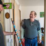 Michael Good, right, shows off his painted walking stick to Trevor Kellar, a community navigator for the St. Vincent de Paul Society, on Friday, July 20, 2018. Kellar helped Good, who has been homeless for most of his life, get a long-term apartment at the societys Smith Hall Senior Apartments. (Michael Penn | Juneau Empire)