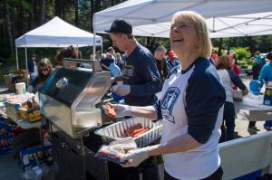 Connie Hulbert, President and General Manager of AEL&P, helps prepare food as the company celebrate its 125th year in business with a public picnic at Cope Park on Friday, July 20, 2018. The public was also invited to tour the Gold Creek Power Plant. (Michael Penn | Juneau Empire)