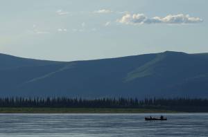 Cora the dog and Ned Rozell float down the Yukon River just upstream from Circle. (Photo by Skip Ambrose)