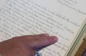 Archivist Zach Jones points out Wyatt Earps July 1900 application for a Nome liquour at the Alaska State Archives on Friday, July 27, 2018. (Michael Penn | Juneau Empire)