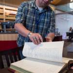 Archivist Zach Jones looks for Wyatt Earps July 1900 application for a Nome liquour at the Alaska State Archives on Friday, July 27, 2018. (Michael Penn | Juneau Empire)