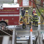 Firemen wait on Franklin Street after responding to a fire at the Channel View Apartments on Sunday.