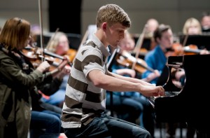 Trevar Fiscus, winner of last year's Youth Solo Competition, practices a Shostakovich concerto with the Juneau Symphony at Thunder Mountain High School on Tuesday.