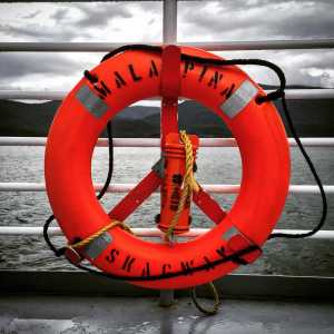 A life ring glows bright orange against the dark sky Friday, Sept. 11 aboard the Malaspina ferry on the way to Skagway for the Klondike Road Relay.
