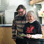 Visiting NYC poet Bob Holman helps Juneau poet Nora Marks Dauenhauer back to her seat after her reading at Kindred Post Saturday.