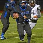 Thunder Mountain senior running back Q'on bear-Clark (7) moves past Nikiski linebacker Luke Johnson during Friday's 28-21 Falcons loss to the Bulldogs.