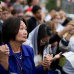 Lita Buenaventura of Toronto prays during Mass conducted by Pope Francis along Benjamin Franklin Parkway on Sunday in Philadelphia.