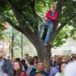 Grace Volton of Dallas watches from a tree along Benjamin Franklin Parkway as Pope Francis conducts Mass Sunday.