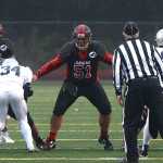 Juneau-Douglas senior Kana Galletes (51) blocks after a snap during high school football action this season.
