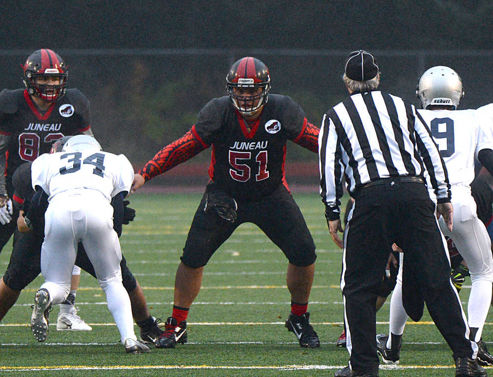 Juneau-Douglas senior Kana Galletes (51) blocks after a snap during high school football action this season.