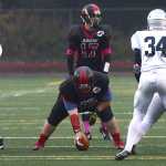Juneau-Douglas senior Patrick Naputi (79) prepares to hike the ball to quarterback Bubba Stults (17) during high school football action this season.